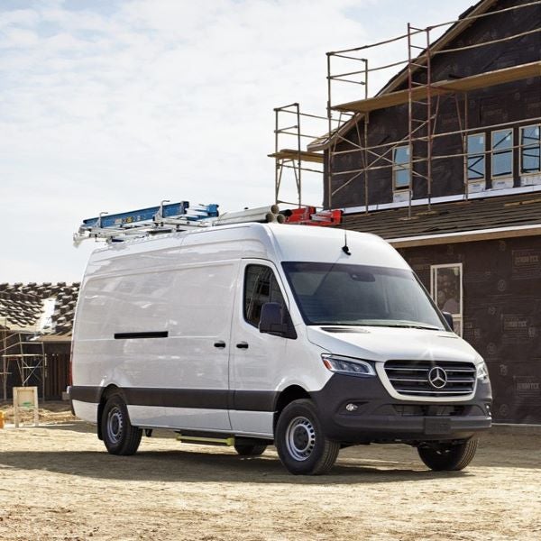 White Sprinter Van parked in front of a construction site